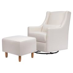 a white chair and footstool sitting next to each other