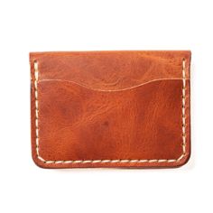 A Leather Wallet that Ages Gracefully and Beautifully.Ever owned a wallet that fell apart after a year or two? Not only do our wallets get better after years of use, but we guarantee it. The rustic English Tan leather stands up to a lifetime of carrying. Drop your wallet while rock climbing, step on it by accident, or run over it in a car. Your experiences will add patina and character to this wallet, not destroy it.Our full-grain leather means your wallet will develop character and patina. We h Full Grain Leather Wallet, Horween Chromexcel, Wallet Minimalist, Horween Leather, Leather Stand, In A Car, Credit Card Wallet, Personalized Keychain, Rock Climbing