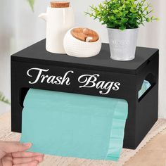 a tissue dispenser is shown with a potted plant on the top