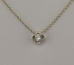 "18 kt white gold pendant. Set with 0.15 carat F-VS2 diamond. The Diamond can be upgraded in size or quality or lesser size and quality. The pendant comes with an 18 kt 1.1 mm 16\" cable chain.                The Diamond is certified. Als available in yellow gold or Platinum." Formal Sterling Silver Solitaire Necklace With Square Pendant, Formal Solitaire Necklace With Square Sterling Silver Pendant, Solitaire Necklace With Diamond Accents And Square Pendant, Formal Solitaire Necklace With Square Diamond Pendant, White Gold Solitaire Square Pendant Necklace, White Gold Solitaire Necklace With Square Pendant, White Gold Square Pendant Solitaire Necklace, Formal Solitaire Necklace With Brilliant Cut Square Pendant, Formal Square Pendant Solitaire Necklace With Brilliant Cut