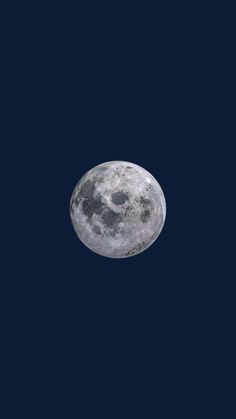 an airplane flying in front of the moon with dark blue sky behind it and no clouds