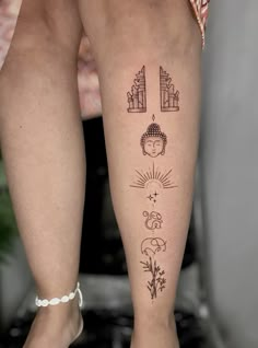 a woman's legs with tattoos on them, including an angel and the sun