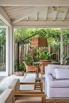 a living room filled with furniture next to a wooden fence