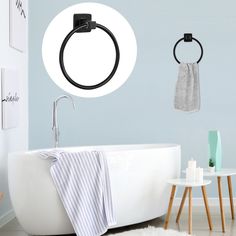 a white bath tub sitting next to a wall mounted toilet paper dispenser