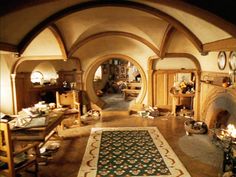 a living room filled with furniture and a fire place in the middle of an archway