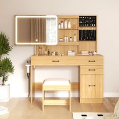 a wooden desk with a mirror, stool and plant in the corner next to it