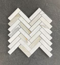 a white marble herringbone pattern on the floor