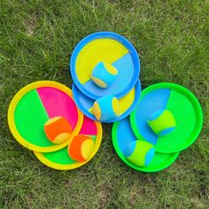 three bowls and one plate on the grass