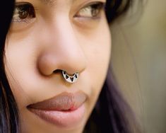 a close up of a person with a nose ring