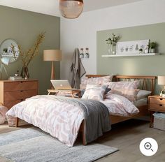 a bed room with a neatly made bed and two nightstands next to each other