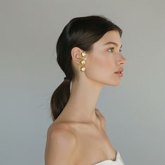 Take any outfit to the next level with our Kahlo Ear Cuff. No piercing required, the Kahlo Cuff slips on and displays a burst of florals along the length of the ear. Sold individually. Our Verano Collection came to life after unearthing an archive of post war filigree and metallic flowers. These intricate & lightweight elements combine with marigold, lapis and olive colored vintage stones to create a moody bouquet of statement earrings, plucked from the dressing room of Casa Azul. 100% Recycled Olive Color, Upcycled Jewelry, Ceramic Flowers, Vintage Brass, Statement Earrings, Ear Cuff, Cuff, Floral, Gold