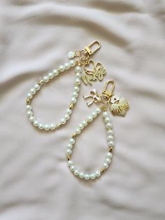 Pearl keychains to accessorize your wristlets, airpods or use as a cute keychains. Also makes perfect gifts for loved ones. Circumference is 9 inches. Comes with an optional white letter charm White Bag Charm Keychain For Everyday Use, White Keychain With Key Clip For Gift, White Keychain With Key Clip Gift, Trendy White Keychain For Gifts, Trendy White Personalized Gift Keychain, Trendy Key Clip Keychain As Gift, Trendy Keychain With Key Clip For Gift, Trendy White Keychain With Key Leash, Cute White Keychains For Everyday Use