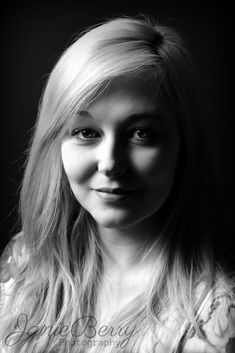 a black and white photo of a woman with long blonde hair