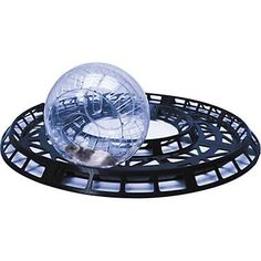 a clear ball sitting on top of a black plate with holes in the bottom and sides