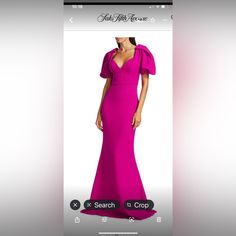 a woman in a pink dress is looking at her cell phone while she's wearing an evening gown