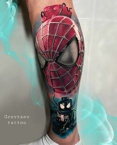 a spiderman tattoo on the leg of a man with a black cat and red mask