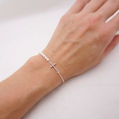 SOLID STERLING SILVER PARTS - A QUALITY BRACELET This lovingly hand-made bracelet is crafted using a solid sterling silver cross that measures just under 3/4 inch long. A row of 5 tiny Swarovski pearls come in your choice of 5 colors. The sturdy sterling silver chain and lobster clasp make this a durable bracelet. Comes in a gift box. SIZING - IMPORTANT: To determine bracelet size, measure snugly around your wrist and add 1/2 inch to get your bracelet size. Do NOT order in your exact wrist measu Bracelet With Pearls, Silver Cross Bracelet, Girls Bracelet, Pearl Bracelet Wedding, Tiny Cross, First Communion Gifts, Long A, Bridesmaid Bracelet, Cross Bracelet