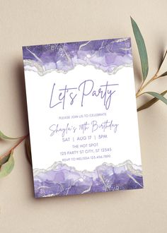 a purple and white party card on top of a table