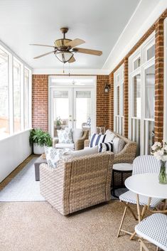 a living room filled with furniture and windows