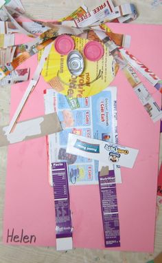 an art project made out of pink paper with scissors and other items on the table