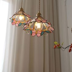 three lights hanging from a ceiling in a room