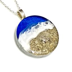 "These realistic beach pendants are made with layers of resin, bright colorful inks and real sand with a 3D silver turtle on the beach. They include 20\" silver plated plated chain. These are made to order and yours may be slightly different than those pictured." Ocean-inspired Silver Resin Necklace, Resin Round Pendant Jewelry For Beach, Silver Necklace With Large Pendant For Beach, Beach Keychain, Sea Turtle Jewelry, Tropical Jewelry, Turtle Beach, Turtle Jewelry, Beach Earrings