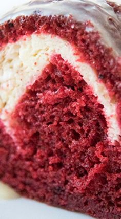 a slice of red velvet cake with white frosting