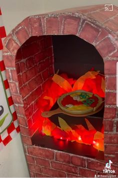 a small brick oven with food cooking in it's door and lights on the side