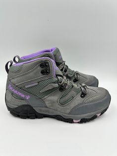 Women's Size 9, Gray High Top Hikers with Purple Accents and Rugged Tread. Hit the trails in style with these gray high-top hikers. With purple accents and rugged tread, these shoes are perfect for outdoor enthusiasts. Whether you're hiking, camping, or just exploring, these hikers will keep you comfortable and supported. Gray Lace-up Hiking Boots For Outdoor, Casual Hiking Boots With Reinforced Toe For Adventure, Gray Waterproof Lace-up Boots For Sports, Casual Durable Hiking Boots For Adventure, Casual High-top Hiking Boots For Adventure, Casual Low-top Gray Hiking Boots, Gray Lace-up Sporty Waterproof Boots, Sporty Gray Lace-up Waterproof Boots, Casual Gray Low-top Hiking Boots