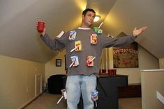 a man standing in a room with food on his shirt and holding up two cups