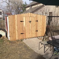 a wooden fence with several doors on it