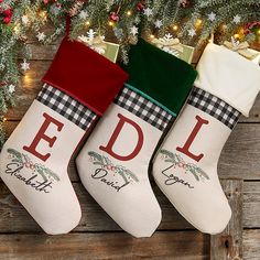 three christmas stockings with the word edl printed on them hanging from a tree branch