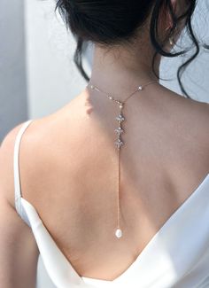 This romantic drop back chain is perfect for your backless bridal gown or evening dresses. Made from fresh water pearl and shinny zirconia charms. You can either choose a multiple pearl or single pearl choker style.  Matching earrings & bracelet: https://nikyglam.etsy.com/listing/1506173529 ♥Lead and nickel free ♥Made from shinny and high-quality cubic zirconia crystal  ♥Custom design and length possible ♥Handmade with love ♡JEWELRY DETAILS♡ 【Chain】 Length around neck: 40 - 45 cm / select length Elegant Cubic Zirconia Backdrop Necklace With Delicate Chain, Elegant Dangle Backdrop Necklace With Pearl Drop, Wedding Pearl Lariat Necklace With Dangle, Elegant Lariat Drop Necklace For Wedding, Silver Lariat Necklace With Pearl Chain For Wedding, Silver Lariat Necklace With Pearl Pendant For Wedding, Elegant Teardrop Backdrop Necklace With Adjustable Fit, Silver Pearl Pendant Lariat Necklace For Wedding, Adjustable Wedding Backdrop Necklace With Delicate Chain