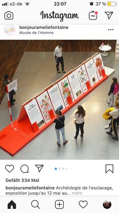 an instagram page with people standing around and looking at information on the display screen