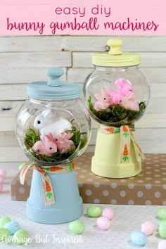 two glass jars filled with fake animals and moss