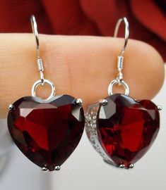 Simulated Red Garnet CZ (Cubic Zirconia) Earrings Heart Design#E38 These are lovely Art Nouveau inspired earrings. The sterling silver filigree outlines man-made red garnet CZ heart-shaped gemstones. The simulated red garnet CZ gemstones are 15mm x 15mm. The color and clarity of the gemstones are simply breathtaking. The earrings are 1.25" long. The beautiful craftsmanship of the silver filigree design has a heavy art nouveau influence with whimsical swirl patterns. This Victorian revival jewelr Red Heart-shaped Cubic Zirconia Jewelry, Red Cubic Zirconia Heart Pendant Jewelry, Elegant Red Heart-shaped Earrings, Sterling Silver Heart Cut Earrings For Party, Elegant Red Earrings With Heart Charm, Elegant Red Heart Charm Earrings, Elegant Red Double Heart Earrings, Red Heart Cut Elegant Earrings, Elegant Red Heart Cut Earrings