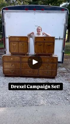 a woman standing in the back of a truck with drawers on it's side