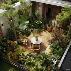 an aerial view of a patio with chairs and tables surrounded by trees, plants and shrubs