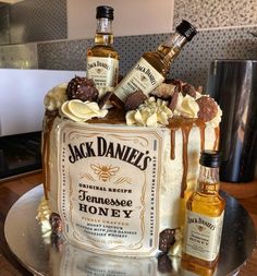 there is a cake that has some liquor on it and two bottles next to it