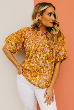 The Kira Floral Woven Top | MOD Boutique Feminine Smocked Top With Floral Print For Vacation, Feminine Summer Smocked Top With Floral Print, Feminine Floral Print Smocked Top For Summer, Summer Feminine Floral Print Smocked Top, Feminine Floral Smocked Top For Summer, Spring Daywear Peasant Top With Relaxed Fit, Pink Floral Print Smocked Top For Vacation, Spring Pink Blouse With Smocked Back, Vacation Smock Blouse With Short Sleeves