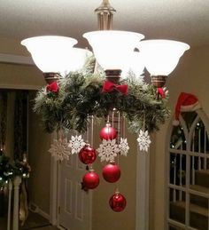 a chandelier with christmas decorations hanging from it