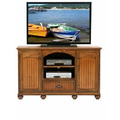 an entertainment center with two boats on the water