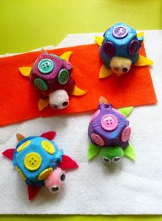 three small toy animals sitting on top of a towel