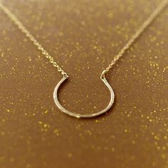 Clementine horseshoe necklace Gold Horseshoe Jewelry For Anniversary, Classic Horseshoe Gold Necklace, Everyday Gold Horseshoe Necklace, Elegant Gold Horseshoe Necklace, Gold Horseshoe Charm Necklaces As Gift, Gold Horseshoe Necklace For Good Luck, Gold Hallmarked Horseshoe Jewelry, Dainty Horseshoe-shaped Jewelry Gift, Horseshoe Necklace Gold