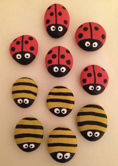 six ladybug magnets with eyes and stripes are arranged on a white surface