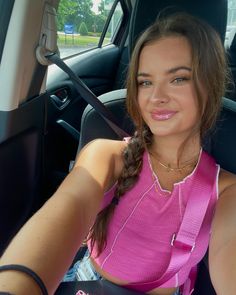 a woman sitting in the back seat of a car