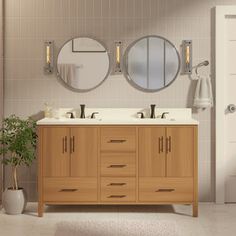 a bathroom with two sinks and three mirrors on the wall above it is also a potted plant