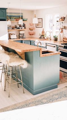 an island in the middle of a kitchen with stools