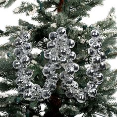 an ornament is hanging from the top of a christmas tree with snowflakes on it