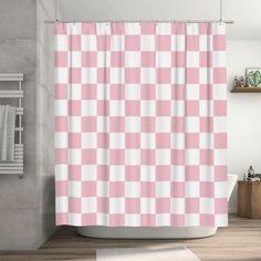 a pink and white checkered shower curtain in a bathroom